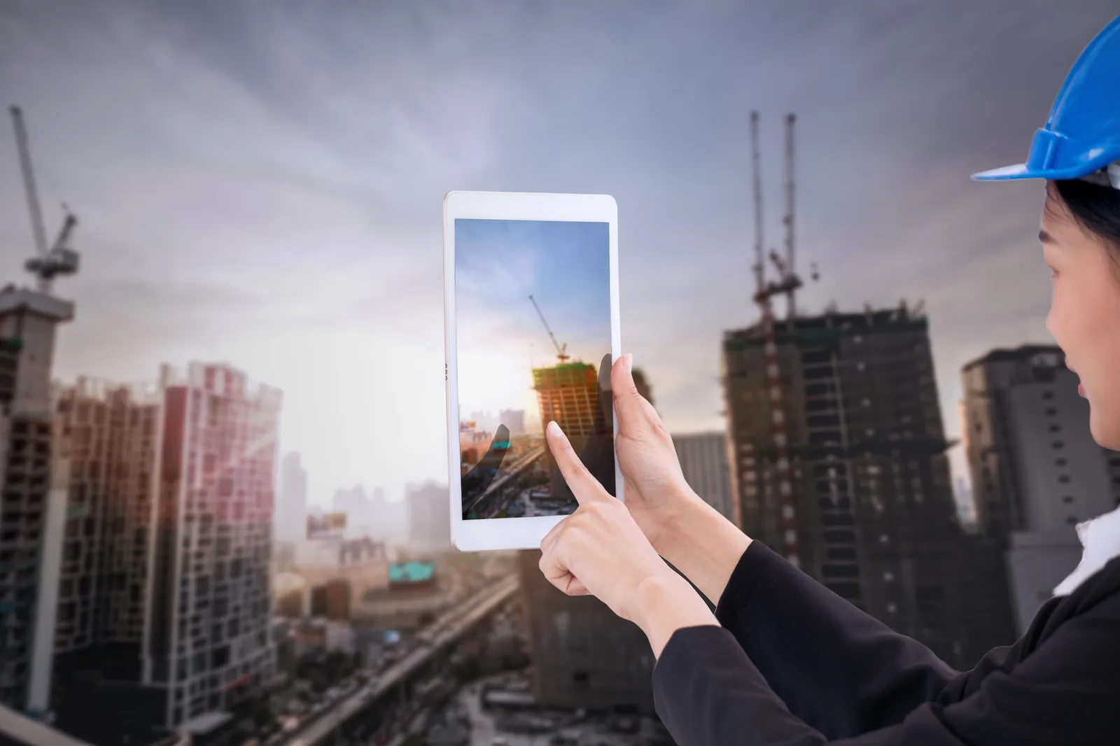 Engineer using tablet to review infrastructure data for a sewer capacity study